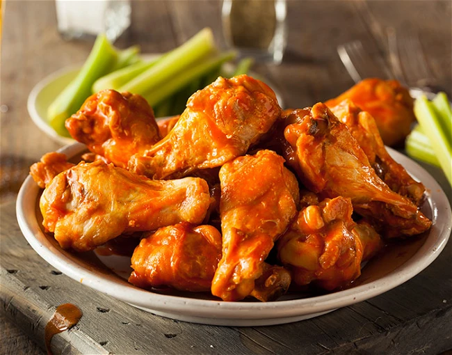 MEAT PLATER  ( Spicy goat, roasted pork)  and buffalo chicken wings