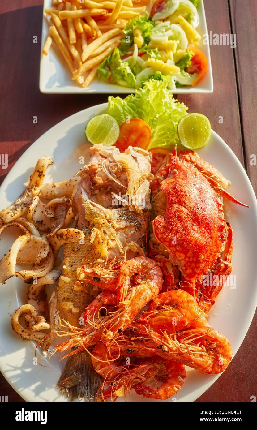 SEAFOOD PLATTER. ( fried squid, spicy grilled prawns) Pan grilled grouper fish, sea muscle served with sweet corn and potatoes