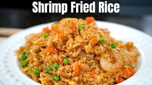 SHRIMPS RRIED RICE.  ( marinated jumbo shrimps sautéed with butter and olive oil Then tossed with fried rice And mix veggies served with Chinese chili sauce